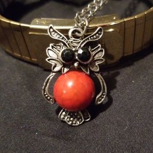 Owl necklace with a red stone belly